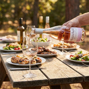 2025 Domaine de Mourchon - Cotes du Rhone Seguret Loubie ROSE (750ml) | Show this bottle of rose wine being poured into a glass at a summer bbq.